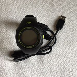 New Balance GPS watch with charger.
